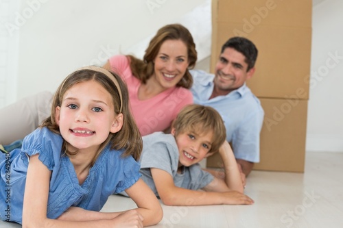 Happy family lying in their new house