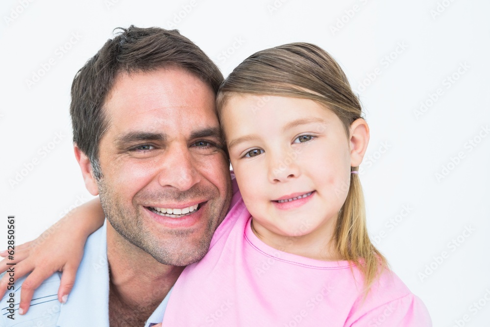 Cute father and daughter posing and smiling at camera together Cute father and daughter posing and smiling at camera together
