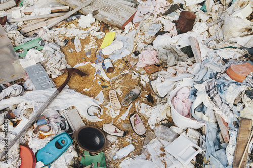 A heap of garbage and discarded items. Wooden plants, plastic and fabric, rubbish.