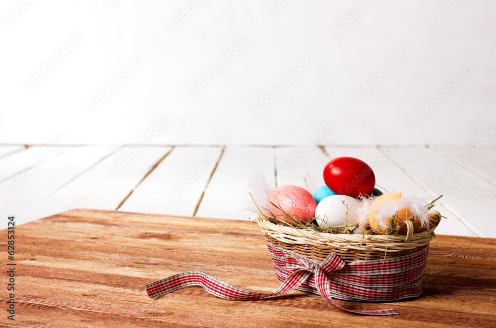 colorful eggs and feathers in basket colorful eggs and feathers in basket