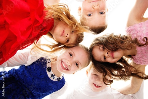 Croup of happy children standing in a circle