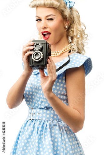 Sexy blond pin up style young woman in blue dress