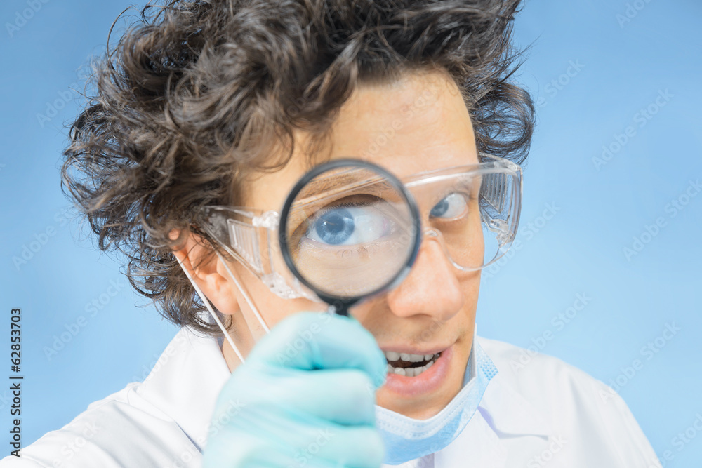 Mad doctor looks through a magnifying glass Mad doctor looks through a magnifying glass