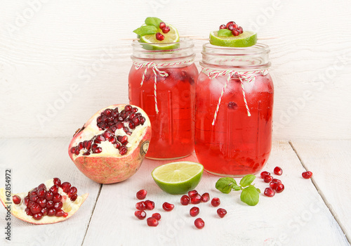 Two glasses with red pomgranate juice, lime and mint. photo