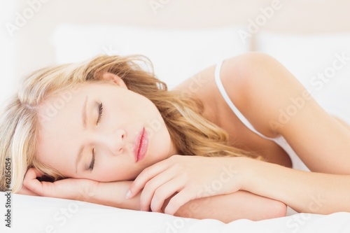 Natural young blonde lying on her bed asleep