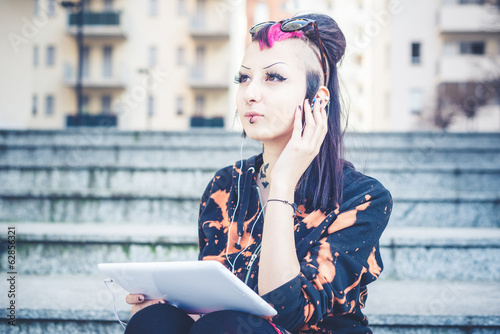 young beautiful punk dark girl listening music photo