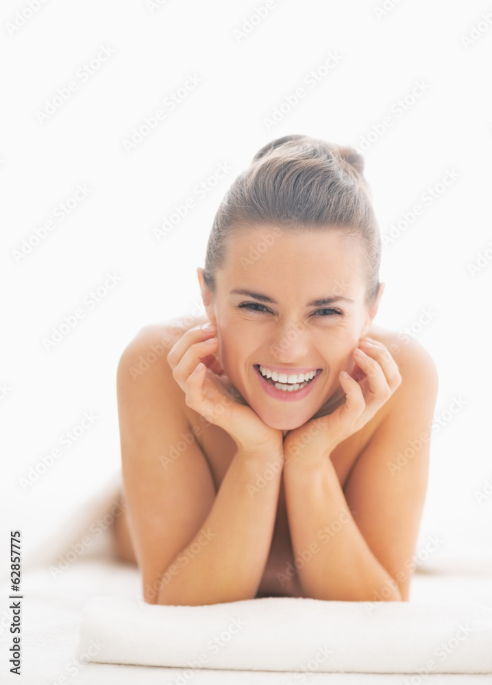 Portrait of smiling young woman on massage table Portrait of smiling young woman on massage table