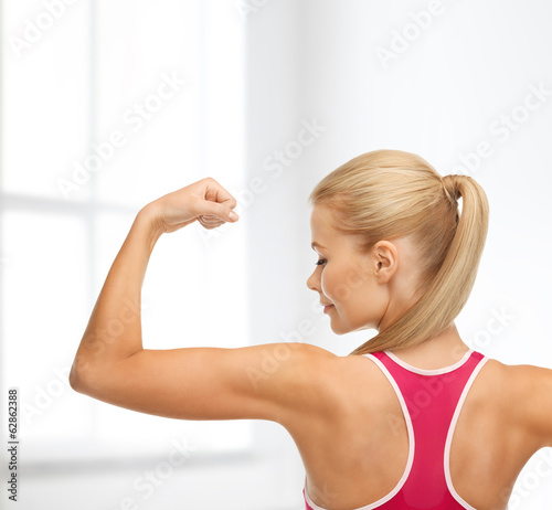 sporty woman showing her biceps