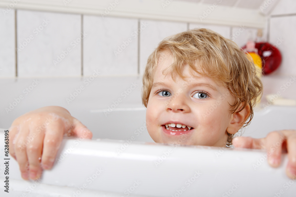 Cute little toddler boy of two years having fun by taking bath i Cute little toddler boy of two years having fun by taking bath i