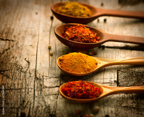 Fototapeta Naklejka Na Ścianę i Meble -  Spices. Curry, saffron, turmeric, cinnamon over wood