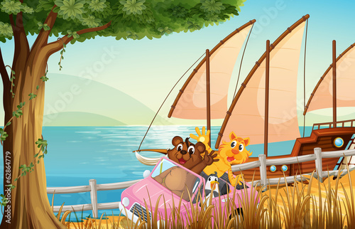 A pink car with animals travelling near the sea