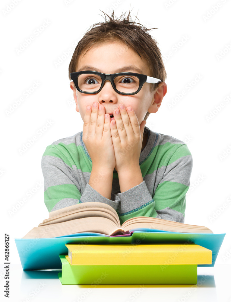 Astonished little boy is reading a book Astonished little boy is reading a book