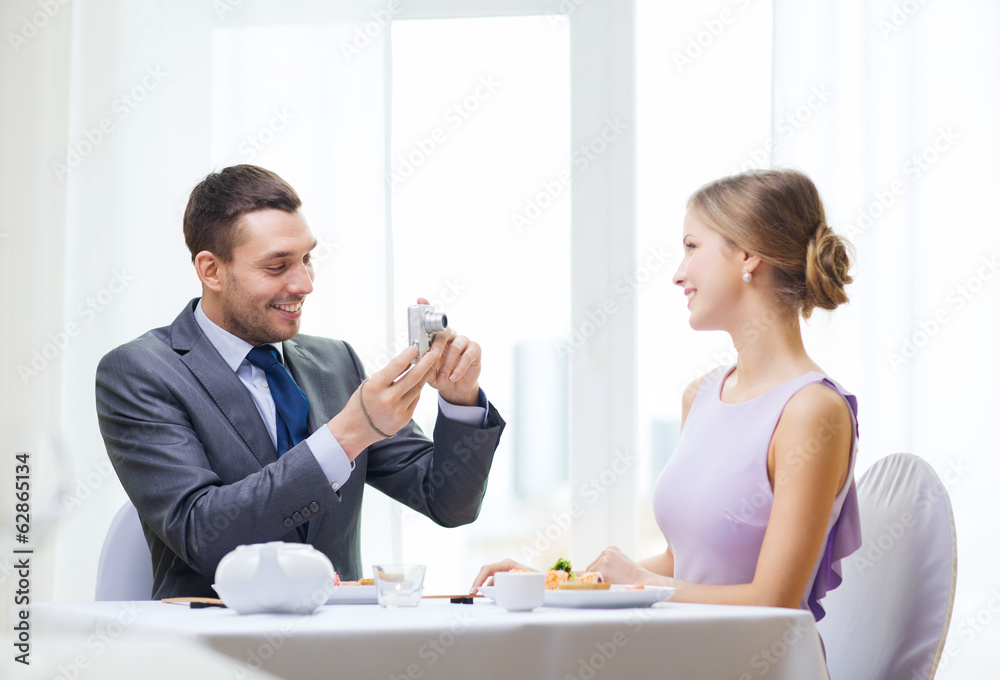 smiling man taking picture with digital camera smiling man taking picture with digital camera