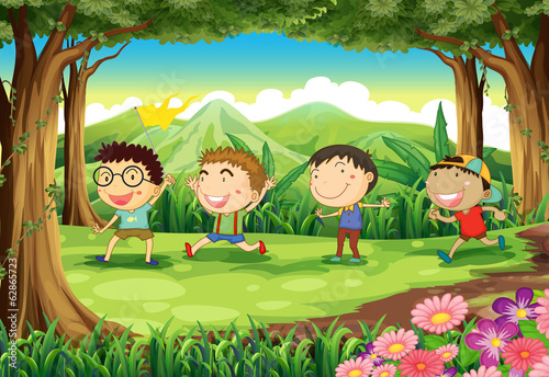 Fototapeta Naklejka Na Ścianę i Meble -  Four playful kids at the forest