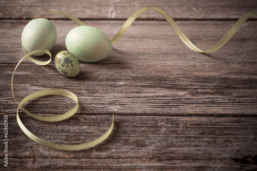green easter eggs on wooden background