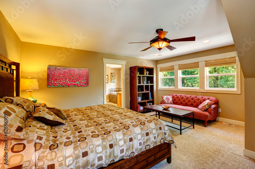 Master bedroom with anitque red couch