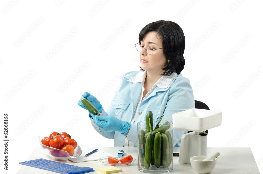 Phytosanitary technician measuring length of cucumber Phytosanitary technician measuring length of cucumber