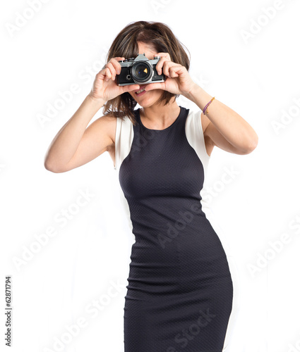 Girl taking a picture over white background