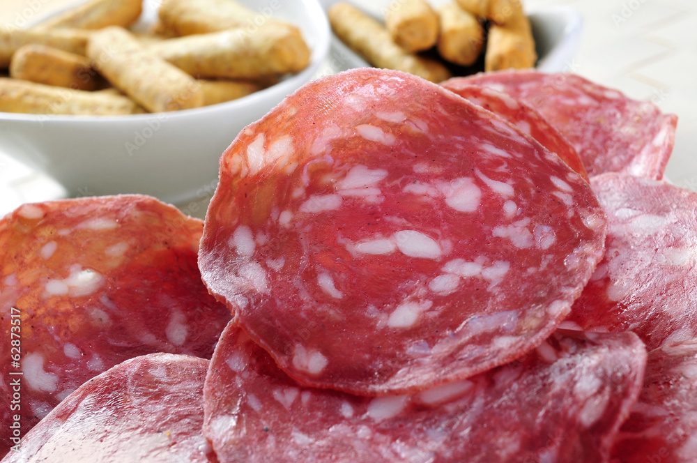 slices of salchichon, spanish cured sausage slices of salchichon, spanish cured sausage