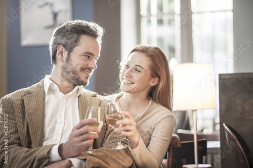young couple toasting in a bar