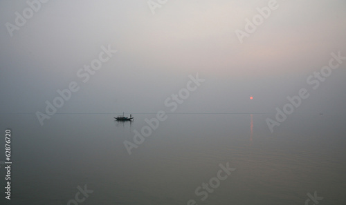 Sunset on holiest river in India. Ganges delta in Sundarbans