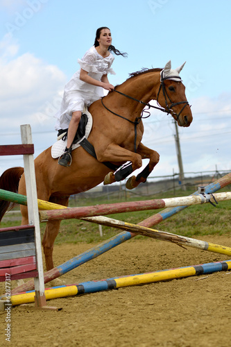 horse jumping with bride