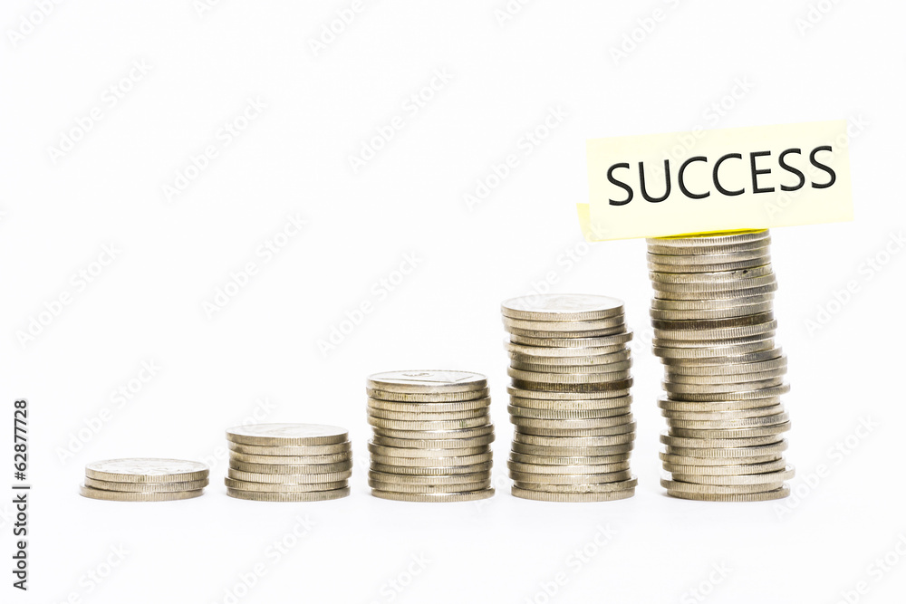 Isolated coins stacked with success label on top Isolated coins stacked with success label on top