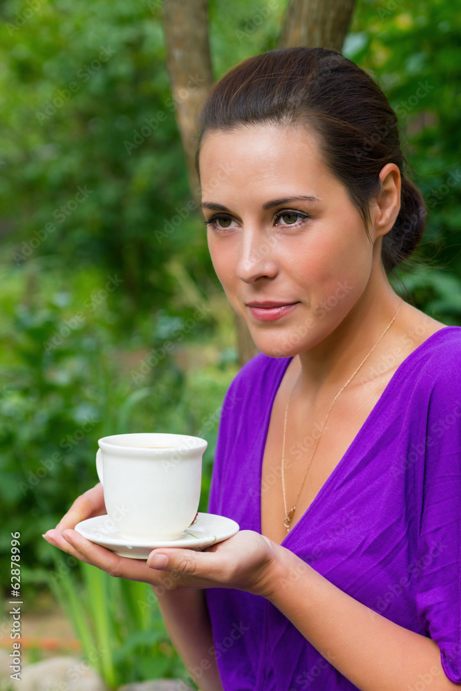 Beautiful young woman drinking coffee outdoors Beautiful young woman drinking coffee outdoors