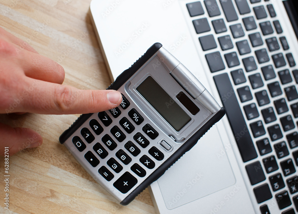 Pushing buttons of an office calculator Pushing buttons of an office calculator