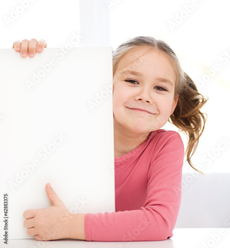 Cute girl is holding blank banner