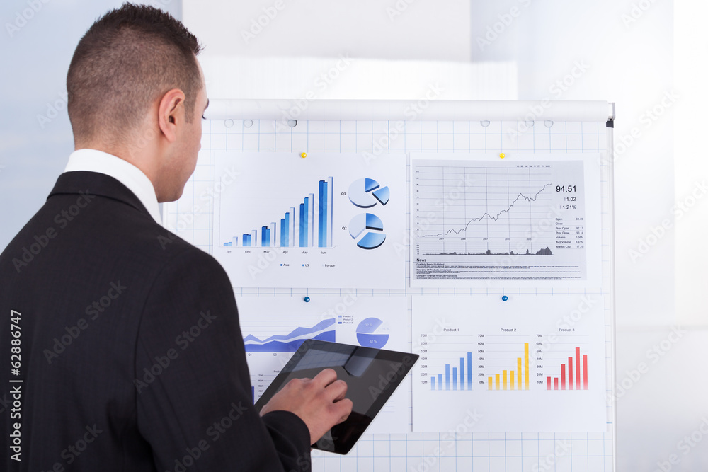 Businessman Analyzing Graph On Digital Tablet Businessman Analyzing Graph On Digital Tablet