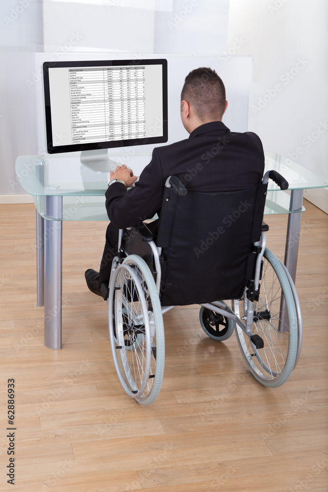 Businessman On Wheelchair Using Computer Businessman On Wheelchair Using Computer