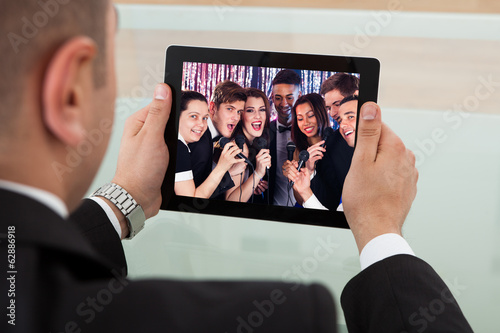 Businessman Listening Karaoke On Digital Tablet
