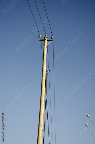 wooden electiric pole on sky background © Alis Photo