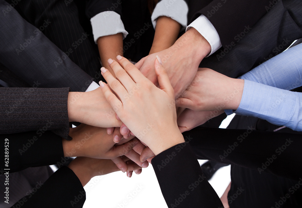 Business people stacking hands Business people stacking hands