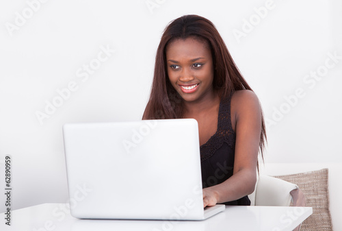 African American woman using laptop at home
