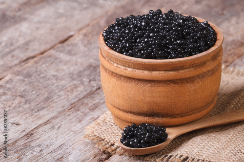 black sturgeon caviar in a wooden a barrel