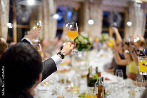 Men's hand holding glass of juice photo