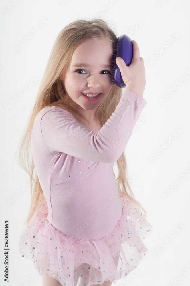 Little girl combing hair