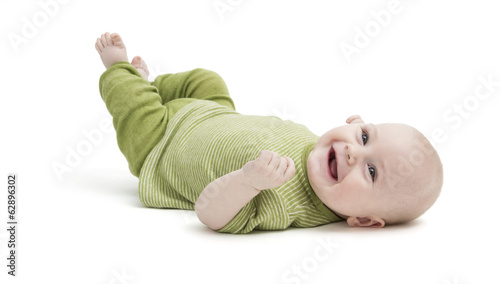 happy toddler lying on his back
