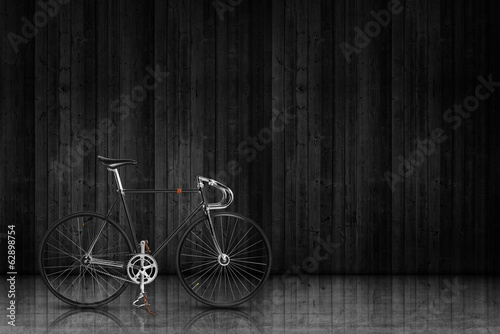 classic fixed gear bicycle on black wood stage