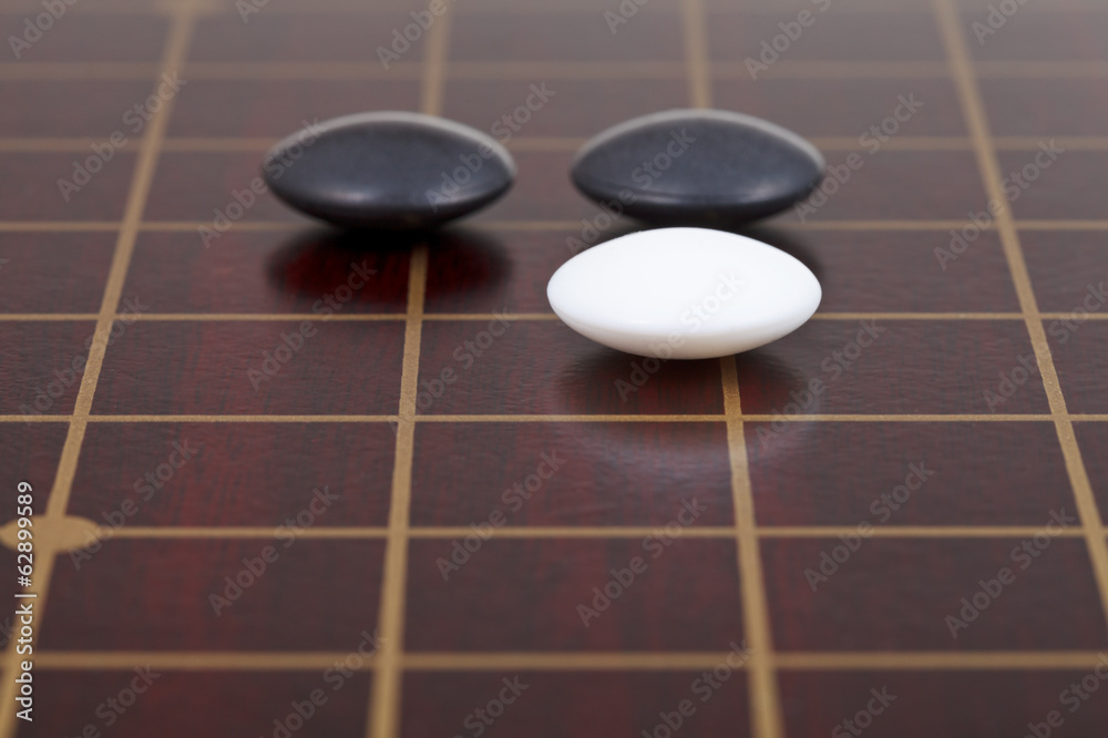 three stones during go game playing on goban three stones during go game playing on goban