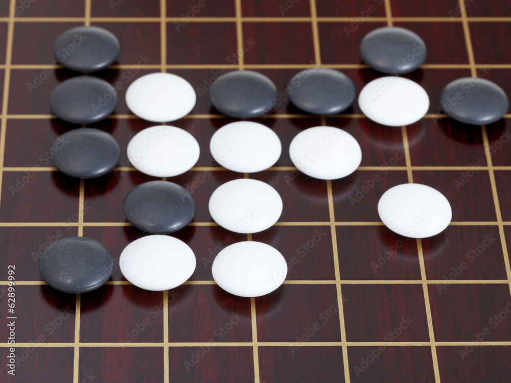 many black and white stones during go game playing many black and white stones during go game playing