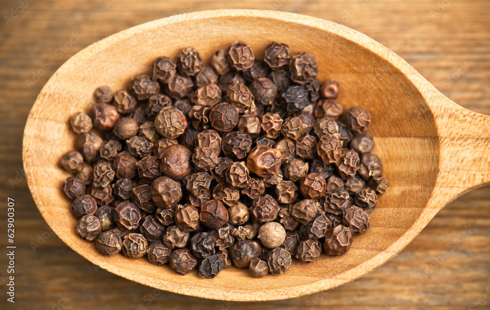 black pepper grains in spoon black pepper grains in spoon