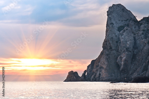 rock in the sea at sunset