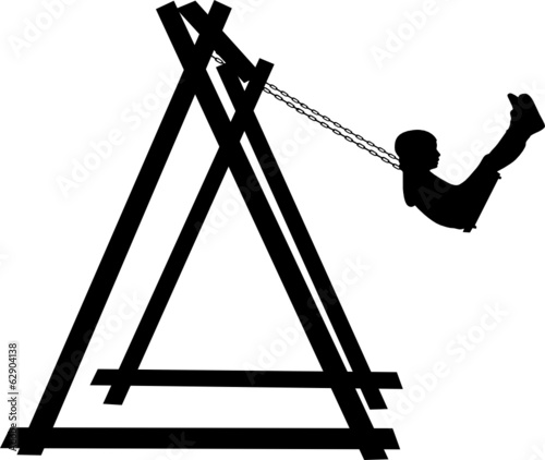 Boy swinging on a swing in the park
