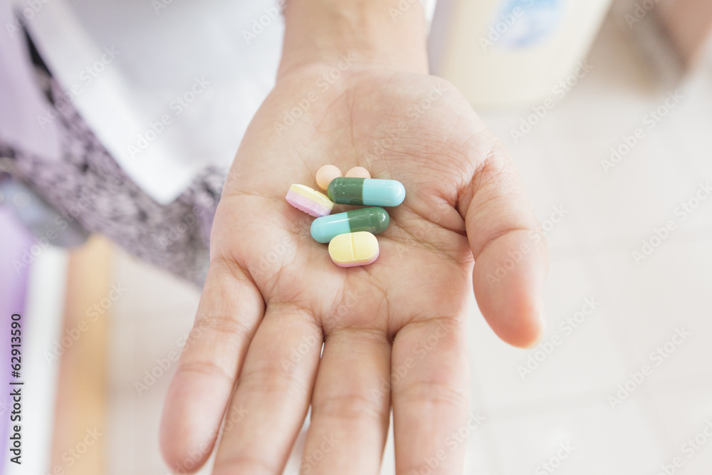 Doctor's hands holding six pills
