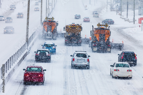 Tree Lined-up Snowplows Clearing the Highway