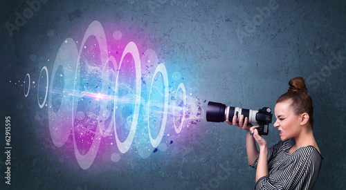 Photographer girl making photos with powerful light beam