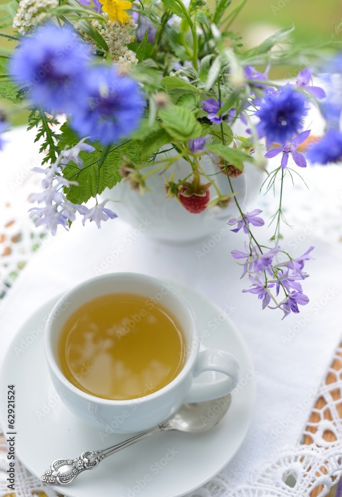 Сup of tea and a bouquet of flowers Сup of tea and a bouquet of flowers